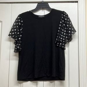 Generation love black top with sheer black and silver polka dots sleeves